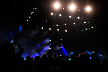 Group of people in outdoor concert, illuminated stage, high technology, powerful sound, latin...