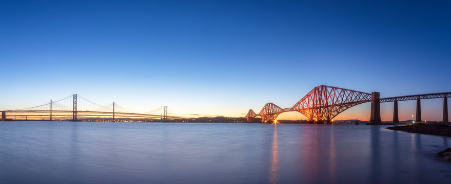 UK, Scotland, Edinburgh, Forth Bridge and Queensferry Crossing Bridge at sunset