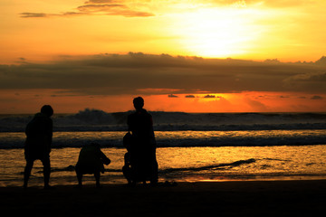 Fototapeta na wymiar Couple on the Beach at Sunset