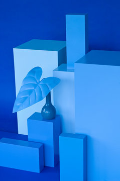 Various cuboids, blue vase with blue leave