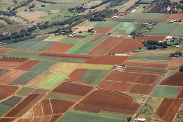 An ariel photo of fields in a square pattern that have been planted and some ready to plant in the...