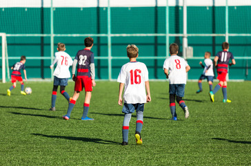 Football training soccer for kids. Boy runs kicks dribbles soccer balls. Young footballers dribble and kick football ball in game. Training, active lifestyle, sport, children activity concept 