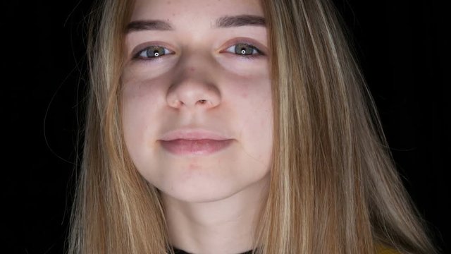Portrait of cute teen girl with long white hair and green eyes poses for the camera in the studio. Teenage Skin and Acne Problems