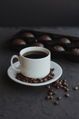 Chocolate cakes and cup of coffee on dark background