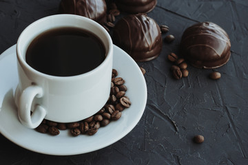 Chocolate cakes and cup of coffee on dark background