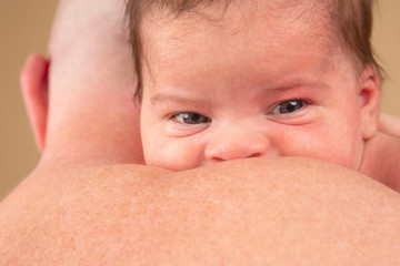 lovely newborn baby on her parent's back