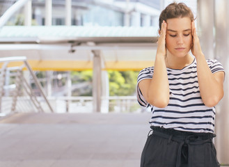 Fototapeta premium Caucasian young woman have a headache and depress at outdoor