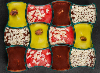 Mini dessert, tiramisu, chocolate and strawberry dessert on dark background.