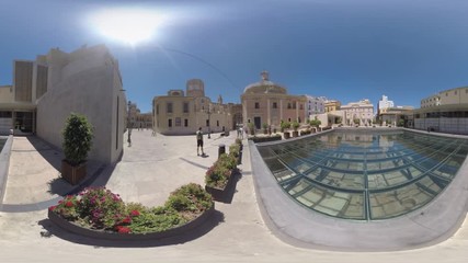VALENCIA, SPAIN - JULY 15 2016: 360 VR video. People walking near Almoina Archaeological Center. Man tourist (with model release) standing by the old city ruins under the glass