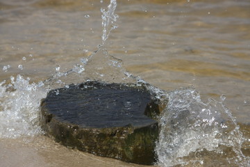 water splashes on rock