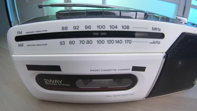 Cool white Radio with cassette player integrated closeup. 1980 1990 era technology.
