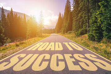 Road to success written on highway in the mountains. Road to success text on the highway.