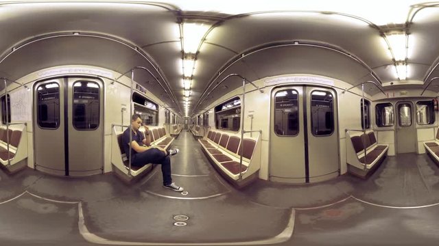 360 VR video. Inner view of moving subway train. Man commuter riding in almost empty carriage. Moscow, Russia