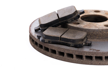 Brake pads and brake discs on white background