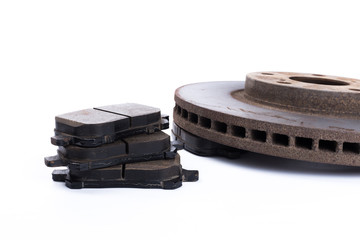 Brake pads and brake discs on white background