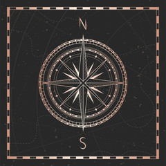 Vector illustration with gold compass or wind rose and frame on dark background. © nadezhdash