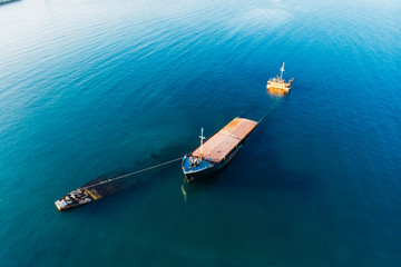 Aerial view of sunken ship near seaside. Shipwreck vessel, drone shot
