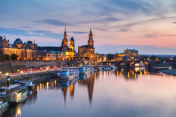 Naklejka na ściany i meble Incredible evening panorama of Cathedral of the Holy Trinity or Hofkirche, Bruehl's Terrace or The Balcony of Europe. Dramatic autumn sunset on Elbe river in Dresden, Saxony, Germany, Europe.