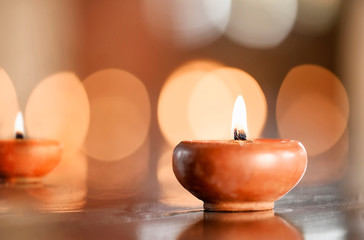Nature pot of candle with light, copy space for text or product display.