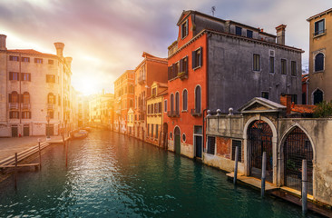 View of the street canal in Venice, Italy. Colorful facades of old Venice houses. Venice is a popular tourist destination of Europe. Venice, Italy.