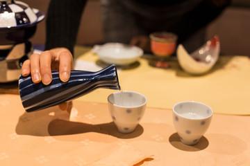 Isolated Japanese Sake drinking set. Liquor bottle and cup for sake