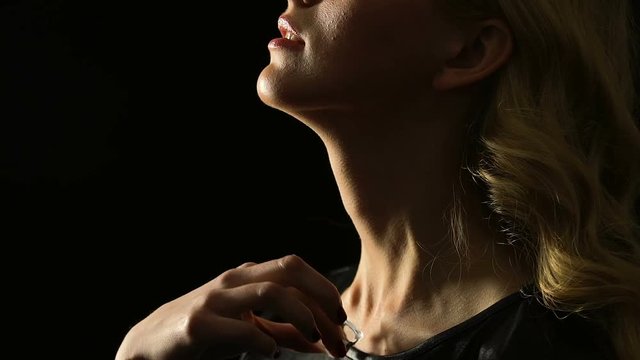Seductive woman stroking neck with ice cube, skincare and cosmetology concept