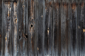 Naklejka premium The texture of the old wooden fence dark color