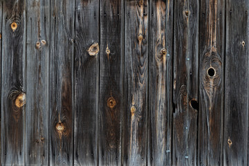 The texture of the old wooden fence dark color