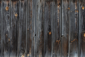 Fototapeta premium The texture of the old wooden fence dark color