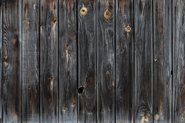 Naklejka premium The texture of the old wooden fence dark color