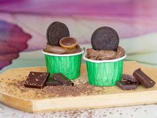 Fototapeta na wymiar Delicious beautiful chocolate cupcakes on a wooden board