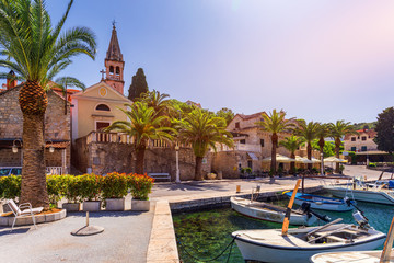 Fototapeta premium Fishing boats in Splitska village with beautiful port, Brac island, Croatia. Village of Splitska on Brac island seafront view, Dalmatia, Croatia, Croatia.