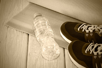 Yoga Mat, athletic shoes, bottle of water, the concept of a healthy lifestyle, healthy diet, sport and diet, Toning grey.
