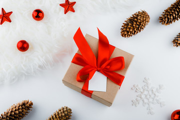 Gift wrapping. Packaging modern christmas present boxes in stylish gray paper with satin red ribbon. Top view of hands on white table with decoration
