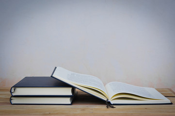 Old book on wood desk,soft focus.