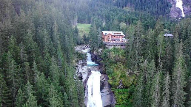 (Aerial) Flying the drone heading towards the house (restaurant) at the Krimml Waterfalls in Salzburger Land. One of the highest, most spectacular waterfalls in europe.