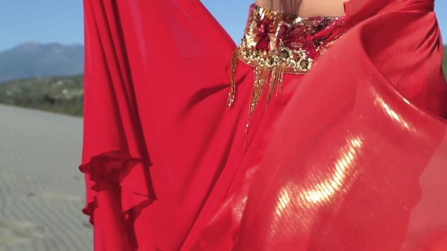 Bellydancing red skirt fluttering in the wind on the Turkish Patara beach. Filmed in slow motion.