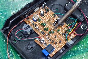 Technician repairing electronic of the computer circuit board by soldering Irons, concept ...