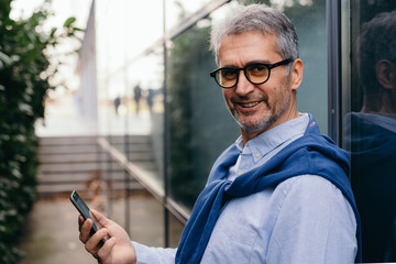 Senior businessman using cellphone outdoor