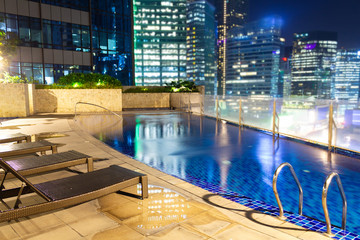 Travel destinations and hotels offering urban retreats and beautiful swimming pools at night in...