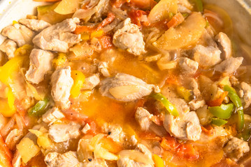 Cooking curry chicken and apples in a large frying pan - Asian cuisine.