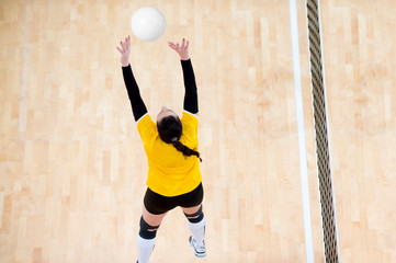 Girl volleyball player setting the ball during a volleyball game