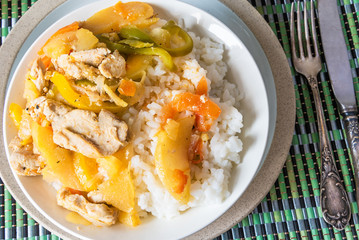 Curry of chicken and apples with rice in a bowl, top view - Asian cuisine.