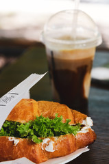Turkey Croissant Sandwiches and a glass of cold coffee.