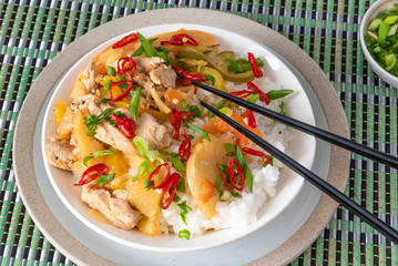 Curry chicken and apples with rice in a bowl and chopsticks, top view - Asian cuisine.