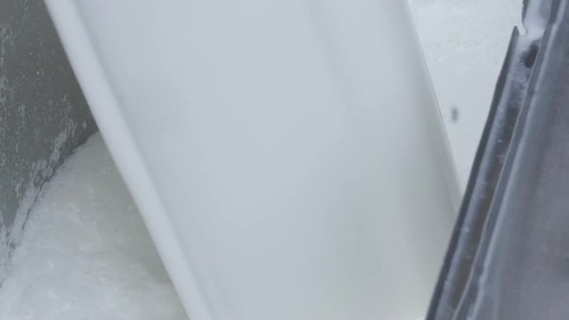 A close up view of Milk filling in a container, Making froth at the top, Slow mo