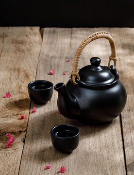 Cup of hot tea with steaming jugs on the wooden table background with copyspace for your text, Chinese style