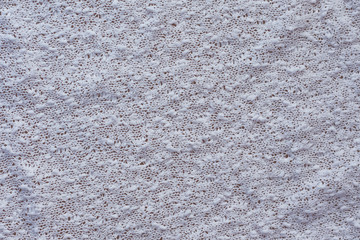 textured background of white knitted fabric top view close-up