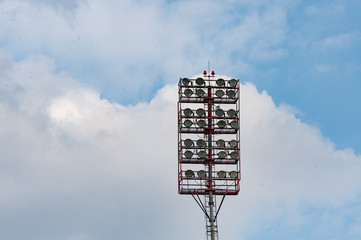Stadium light against blue sky. High mast of spot light.