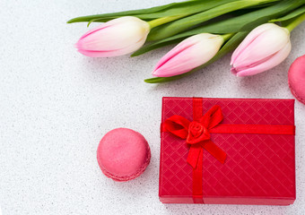 festive composition, delicate tulips and almond cookies with a gift box